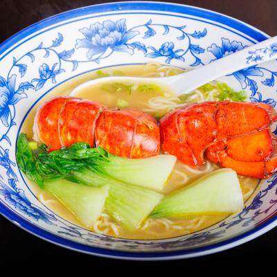 Lobster noodle soup with bok choy.
