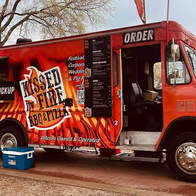 Red food truck with prominent graphics of flames and name in balck and white.