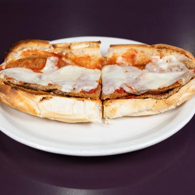 Eggplant Parmigiana sandwich topped with melted cheese.
