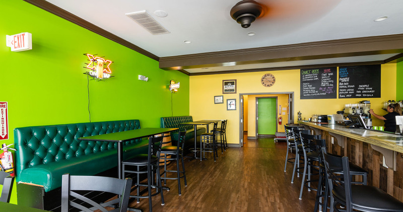 Interior, tall tables and bar on the right