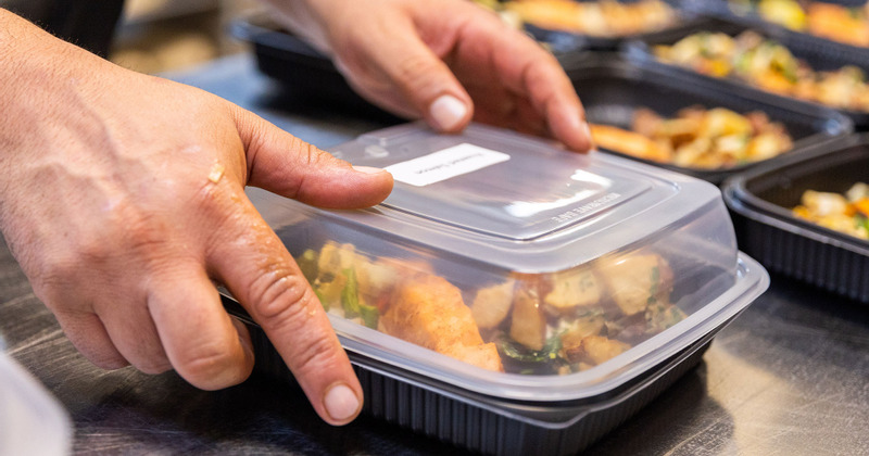 An employee preparing food for delivery
