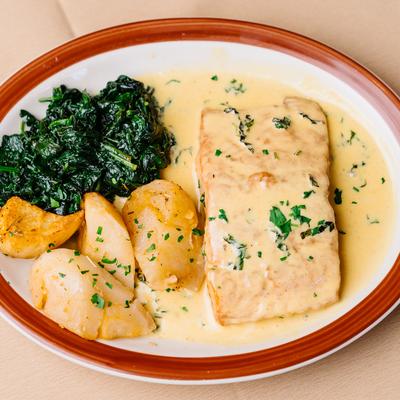 Salmon basil, sauteed spinach and potatoes, top view.