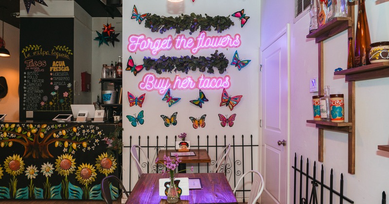 Diner area, table and chairs, decorated wall