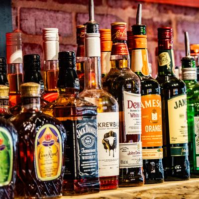 Stocked bar shelf featuring a variety of distilled spirits.