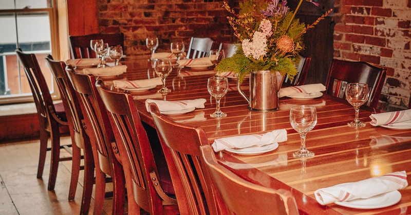 Guest table with tableware and wine glasses close up