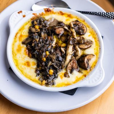Oaxacan cheese dip topped with mushrooms and corn.