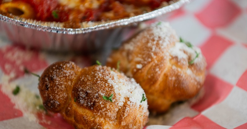 Garlic knots topped with grated cheese and herbs