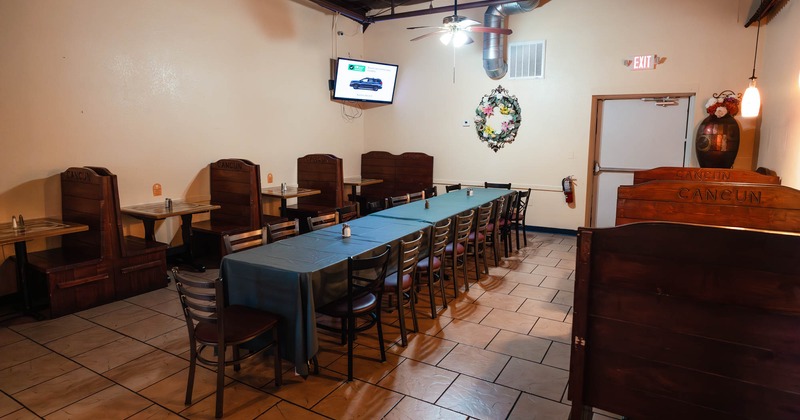 Interior, long table with chairs in the middle, wooden booths on both sides