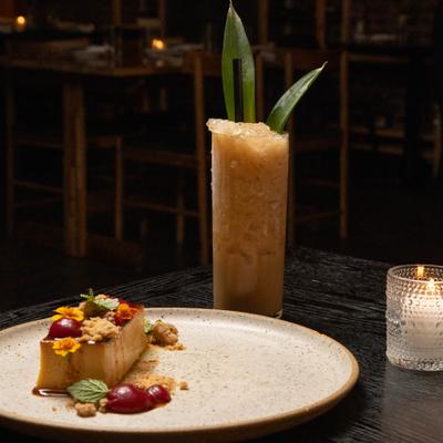 Dessert served alonside a cocktail in a highball glass.