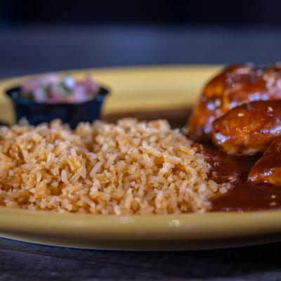 Close-up of chicken and rice with gravy.