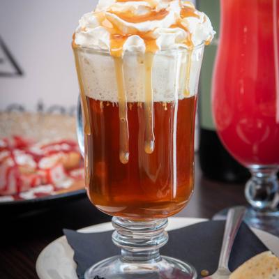 Hot apple cider topped with whipped cream.