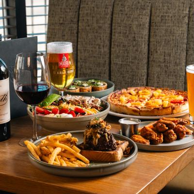 Various dishes served on the tabe with red wine and beer.