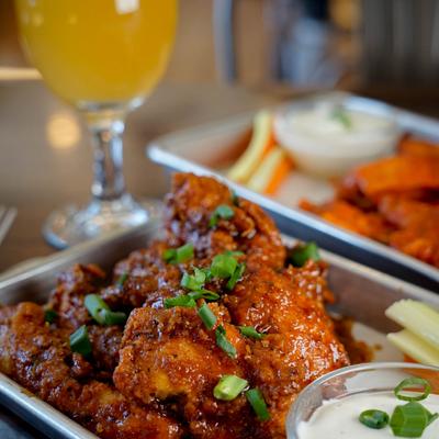 BBQ wings with sauce, celery and carrot sticks