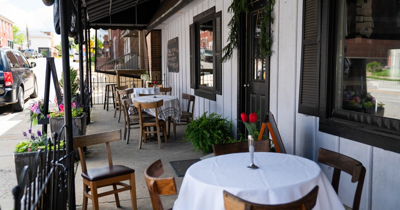 Outdoor cafe scene with wooden tables on a sidewalk