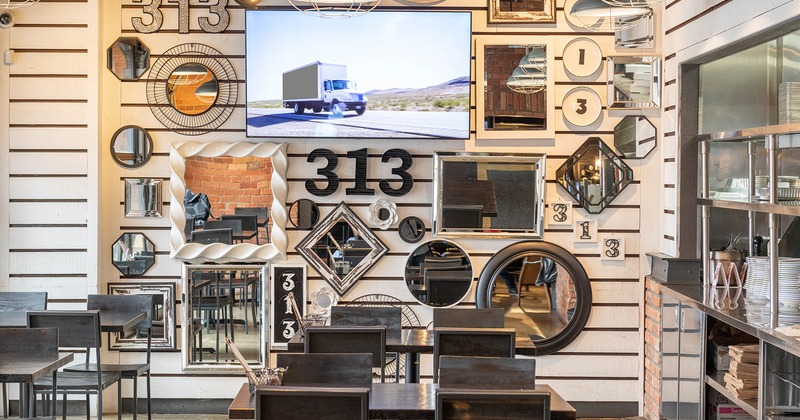 Interior, wall decorated with mirrors of different shapes and sizes, wall TV