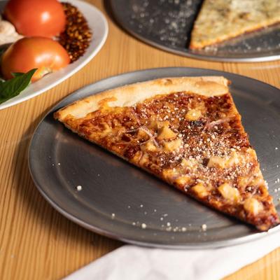 Slice of pizza on the plate closeup