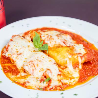 Stuffed pasta shells covered in tomato sauce and melted cheese.