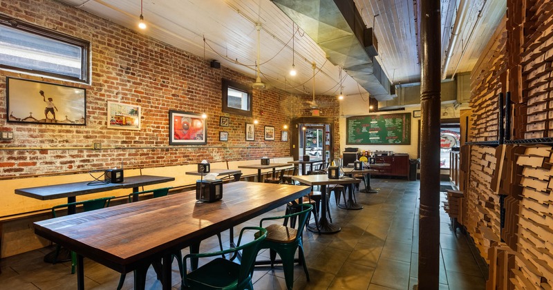 Interior, tables ready for guests, exit door in the back