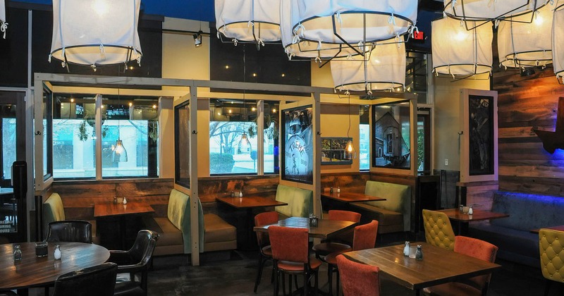 Interior, partitioned booths and tables with chairs