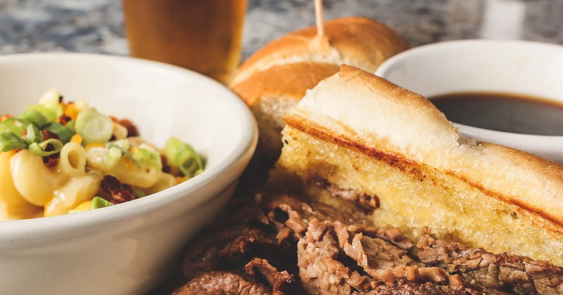 french dip with au jus, mac and cheese with onions and bacon, a beer