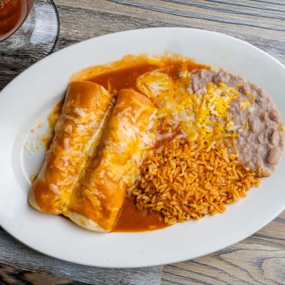 Enchiladas Rancheras served with rice and refried beans.