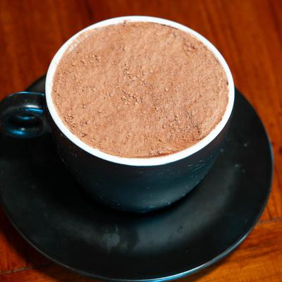 Tiramisu served in a black cup.