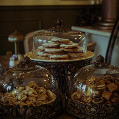 Variety of baked goods displayed under glass cloches.