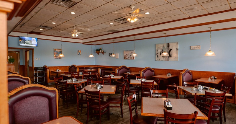 Interior, dining area, tables for four, seating booths for two, ceiling fans