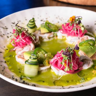 Shrimp cooked in green chile sauce, with red onion, cucumber, avocado, and micro cilantro.