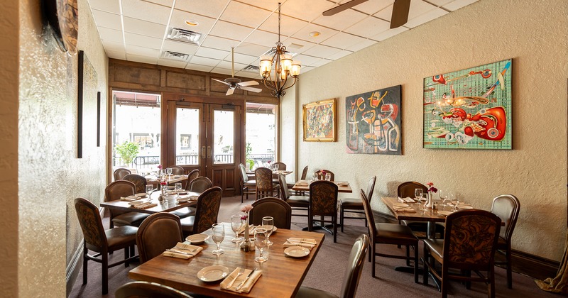 Nicely done interior dining room with set tables ready for guests