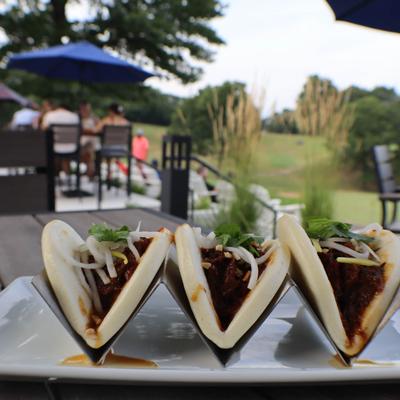 Three Bao Buns served on an outdoor table.