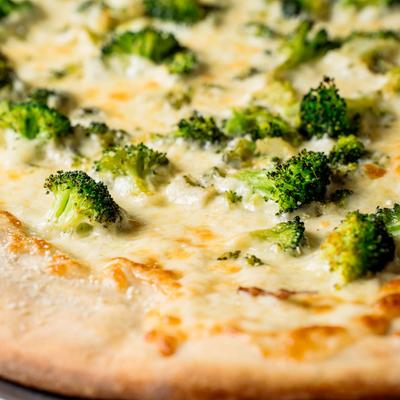 White pizza with broccoli, closeup.