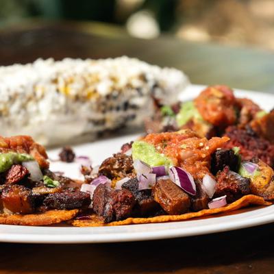 Tacos with mixed meats, and Mexican Street Corn.