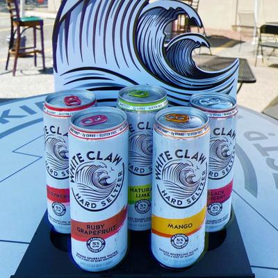 Hard Seltzer cans on a patio table.