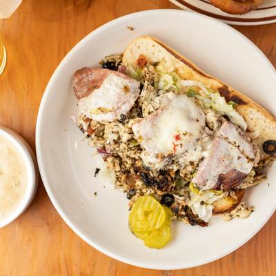 Sicilian sandwich, with chicken, peppers, salami, lettuce, tomato, onion, olives, and cheese.