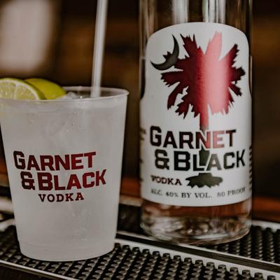 Cocktail drink and a bottle of vodka.