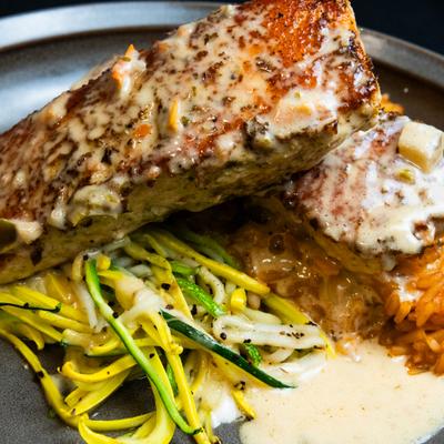 Cilantro Salmon with zucchini and squash noodles, rice, and Santa Fe beurre banc.