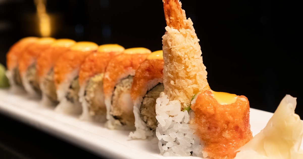 Shrimp tempura roll served on a white plate, close view