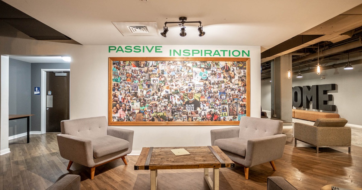 Two big armchairs and tables, big photo collage on the wall