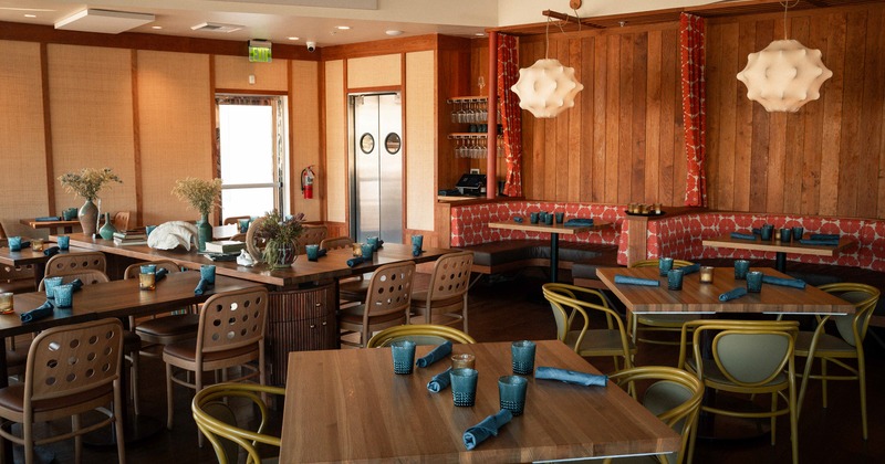 Spacious and cozy interior dining area with set dining tables ready for guests