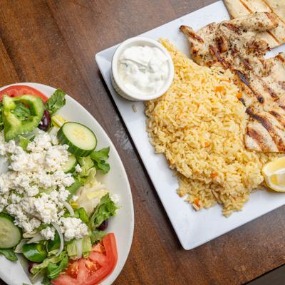 Grilled Chicken Breast plate and a plate of Greek salad.