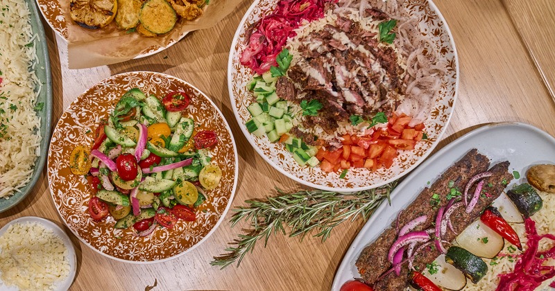 Various food plates spread on a table, top view