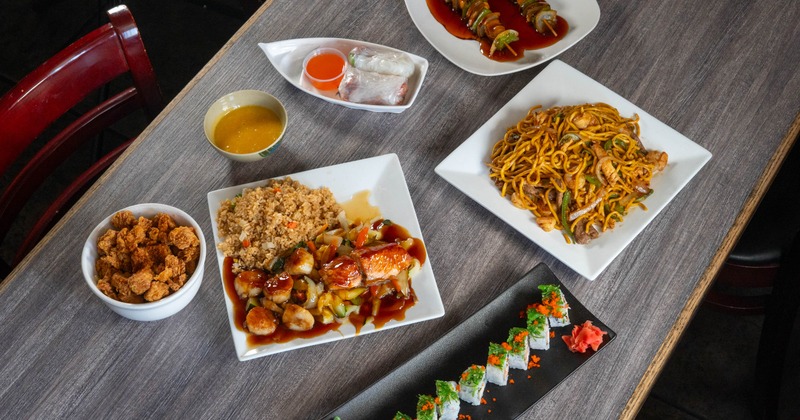 Various dishes served on the table with condiments and sides