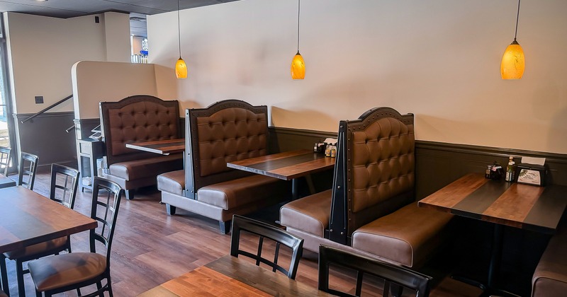 Interior of dining area with upholstered booths along the wall
