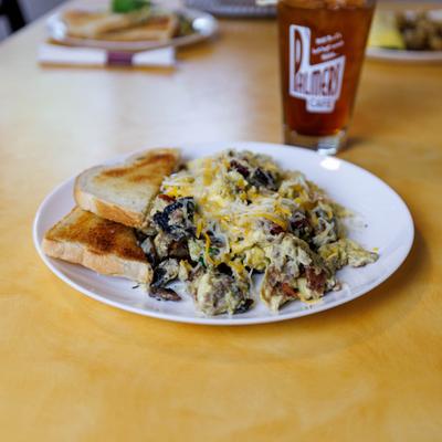 Scrambled eggs with sausage, bacon, mushrooms, Jack cheese, and cheddar cheese.
