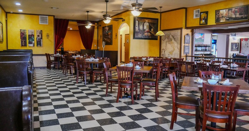 Interior, dining area, wooden top tables for four, ceiling fans, black and white checkered tiles