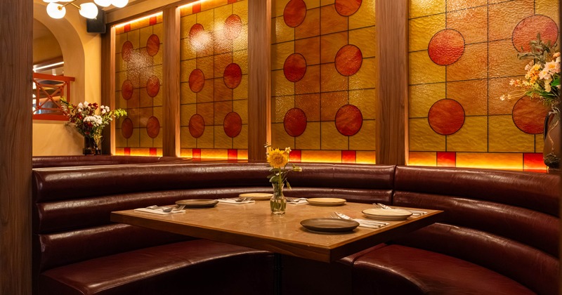 Interior, dining area, closeup on a ''U'' shaped seating booth with marble top table