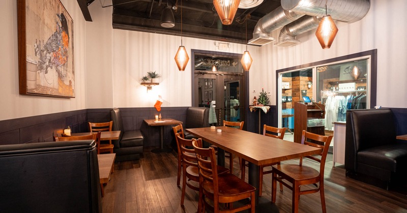 Interior, long wooden table and chairs, leather booth seating