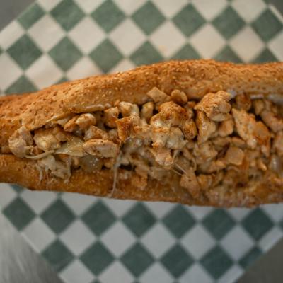 Chicken cheesesteak sendwich on a toasted roll, close-up.