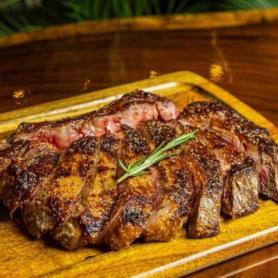 Tomahawk Ribeye served on a wooden board.